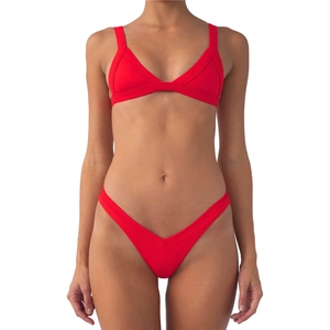 Detailed view of red ribbed fabric texture and seams on a two-piece bikini set