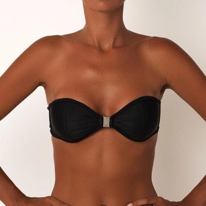 Detail of black bandeau bikini top with a metallic center clasp and logo branding