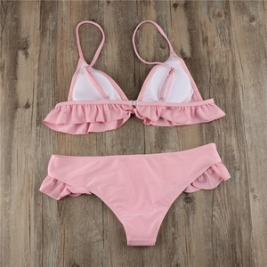 Macro shot of pink ruffle bikini top back with adjustable strap and metal buckle