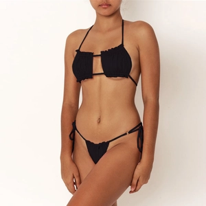 Detail of black pleated bikini top with halter neck and geometric hollow-out design