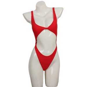 Detail of red one-piece swimsuit with cutout design and knot detail on a white mannequin