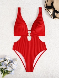 Detail of red ribbed monokini featuring deep V-neck, waist cut-outs and golden metal ring