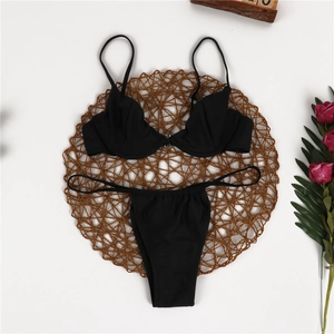 Detail of black underwire bikini top with pleated cups and matching string bottoms