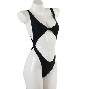 Detailed side view of black cut-out one-piece swimsuit on a display mannequin