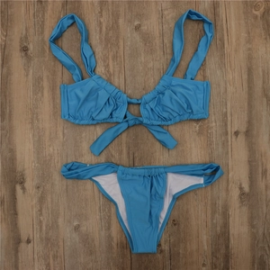 Flat lay of light blue ribbed bikini set with tie-front top and high-cut bottoms