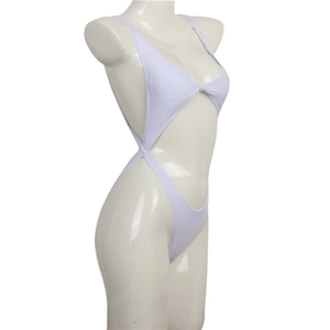 Detail of white cutout monokini with knot front design and high-cut leg opening