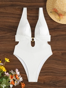 Macro view of white ribbed one-piece swimsuit with V-neck, gold ring, and cut-out details