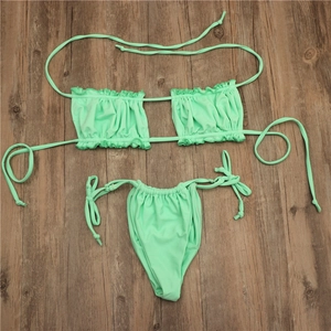 Detailed view of mint green bikini set with ruched bandeau top and side-tie bottoms