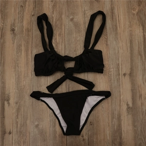 Detail of black two-piece bikini with twist hollow front and long wrap-around waist ties