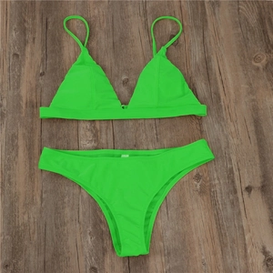 Detailed flat lay of fluorescent green two-piece bikini set with triangle cups and high-cut bottom