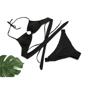 Detailed flat lay of black bikini set featuring metal rings and thin tie-up straps