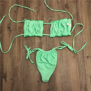 Detail of mint green bikini top with ruffled texture and side-tie high-cut bottoms