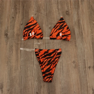 Detail view of tiger print bikini set featuring transparent shoulder straps and high cut design