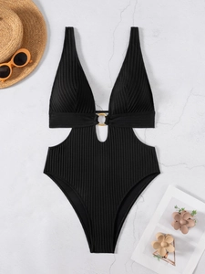 Flat lay of black ribbed one-piece swimsuit with V-neck cutout and gold ring detail