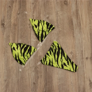 Detail of neon green tiger print bikini with unique clear transparent shoulder straps