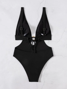 Detail of black monokini featuring deep V-neck, waist cut-outs and golden ring hardware