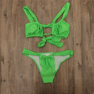 Detailed flat lay of fluorescent green bikini with front knot and high waisted V-cut bottom
