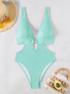 Detailed close-up of ribbed mint green one-piece swimsuit with chic cut-out and golden ring