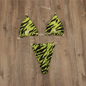 Detailed top view of zebra print bikini with transparent straps on wood background