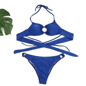 Detail of royal blue bikini with halter neck straps and decorative silver metal rings
