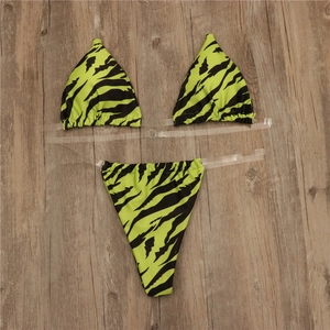 Close-up of zebra print bikini with transparent straps on a rustic wood background