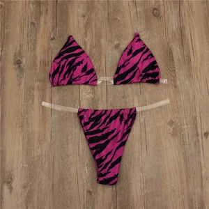 Flat lay of pink zebra print bikini featuring trendy transparent PVC straps and high cut design