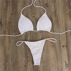 Flat lay of a white string bikini set with halter triangle top and side-tie bottoms