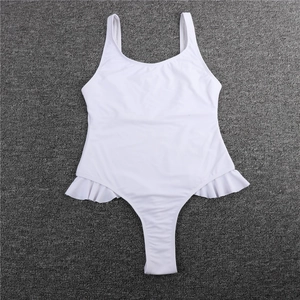Close-up of white one-piece swimsuit featuring ruffled hem detail and ribbed texture