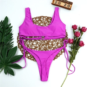 Close-up of fuchsia two-piece bikini featuring a metallic heart buckle and side-tie bottoms