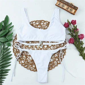 White two-piece bikini with heart-shaped metal buckle on top and side-tie bottoms