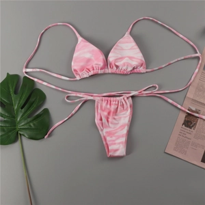 Flat lay view of a pink and white tie-dye bikini set with drawstring side ties