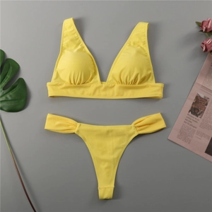 Flat lay of lemon yellow bikini featuring ruched V-neck top and high cut bottoms