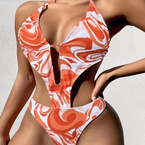 Detail of orange marble print monokini with side cut-outs and silver metal ring connector
