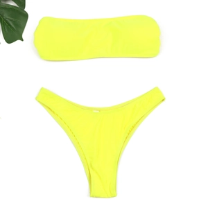 Bikini bandeau jaune néon avec culotte échancrée et décor de feuilles sur fond blanc