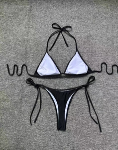 Detailed flat lay of black string bikini set featuring triangle top and side-tie bottom