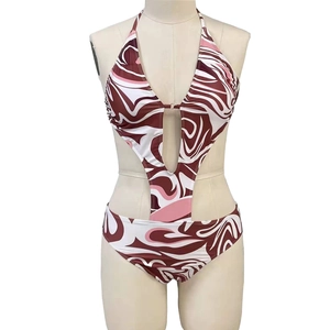 Detail of printed one-piece swimsuit with cut-outs and marble fluid pattern on mannequin