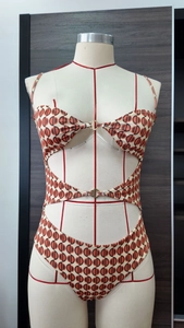 Dettaglio di costume da bagno stampato con design cut-out e anelli in metallo dorato