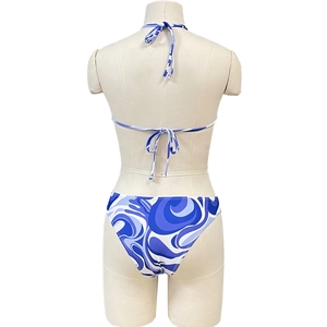 Detail of blue abstract swirl pattern on lace-up bikini back with halter neck ties