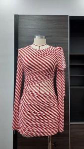 Close-up of ruched red and white striped mini dress with long sleeves and neck tie