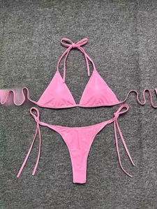 Flat lay view of a pink two-piece bikini set with halter top and side-tie bottoms
