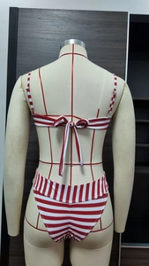 Detail of red and white striped bikini with lace-up back design and high-waisted bottom