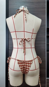 Rear view of two-piece bikini with geometric print and gold metal detailing