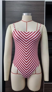 Detail of red and white V-patterned stripe swimsuit on mannequin with high-cut design