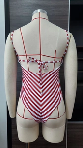 Detailed back view of striped one-piece swimsuit featuring an elegant bow tie design