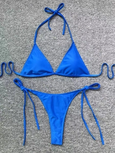 Detailed flat lay of a bright blue two-piece triangle bikini with side-tie bottoms