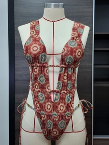 Deep V-neck one-piece swimsuit with bohemian mandala print and side tie details
