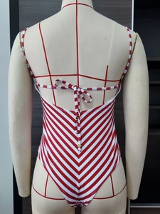 Slim fit red and white striped one-piece swimsuit with thin straps and back bow tie detail