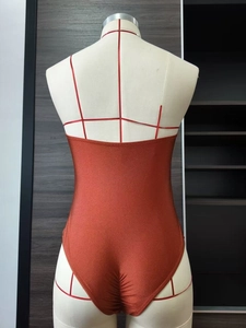 Brick red backless one-piece swimsuit featuring ruched detail and glossy finish