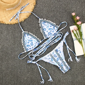 Vue à plat d'un bikini cachemire bleu avec bordure en dentelle et bretelles tressées