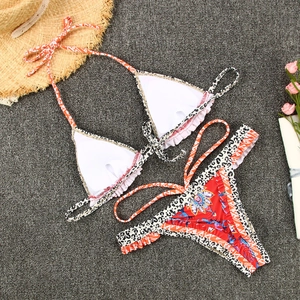 Flat lay detail of printed bikini set with leopard patterns and floral ruffles
